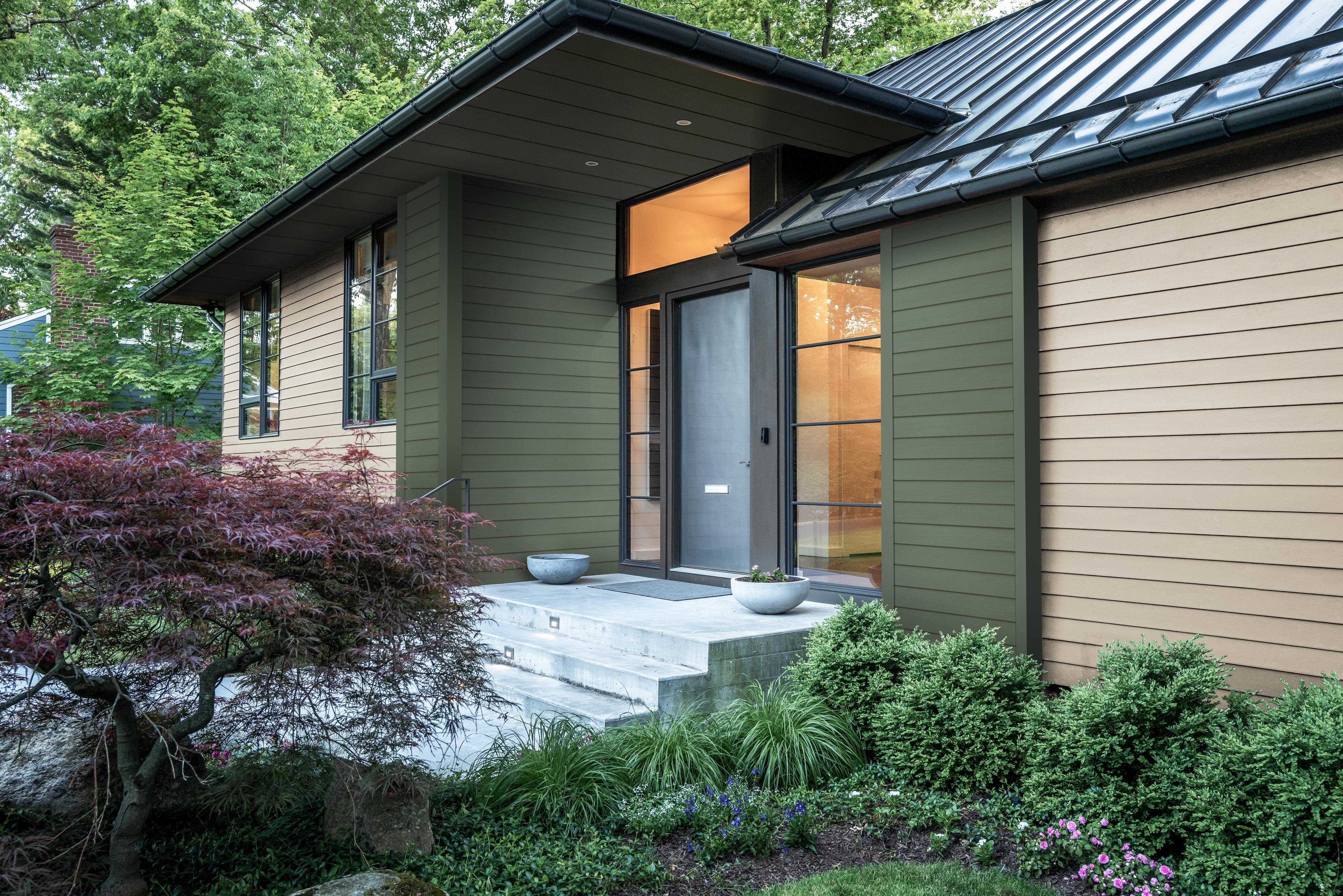 Home clad in Hardie® Plank Lap siding in Weathered Cliffs and a custom green