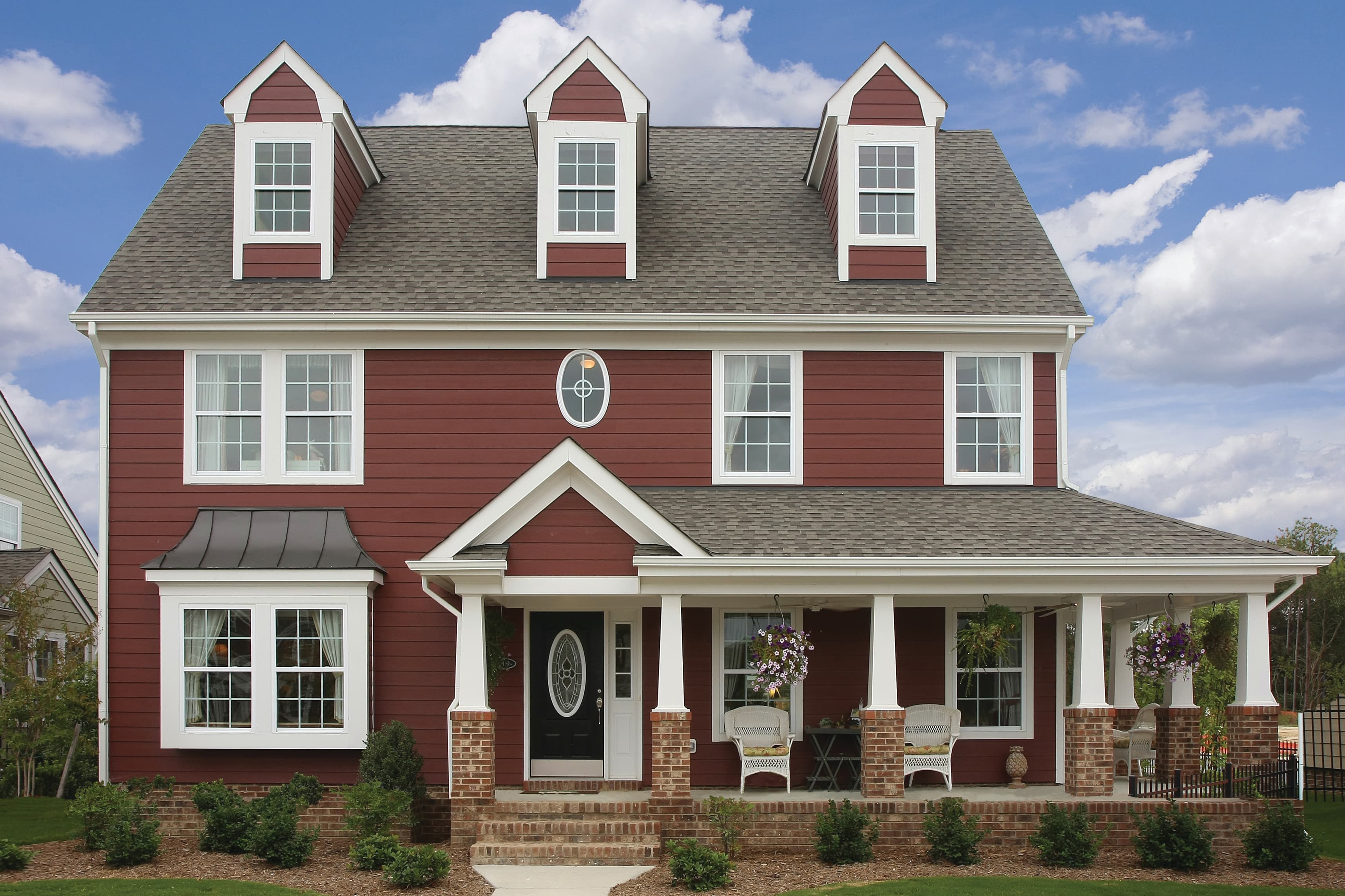 Colonial house clad in Hardie® Plank Lap in custom red