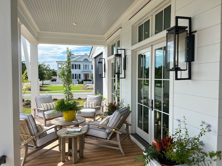 Detail of a porch with large, wrought iron statement sconces. House clad in Hardie® Artisan Shiplap siding.