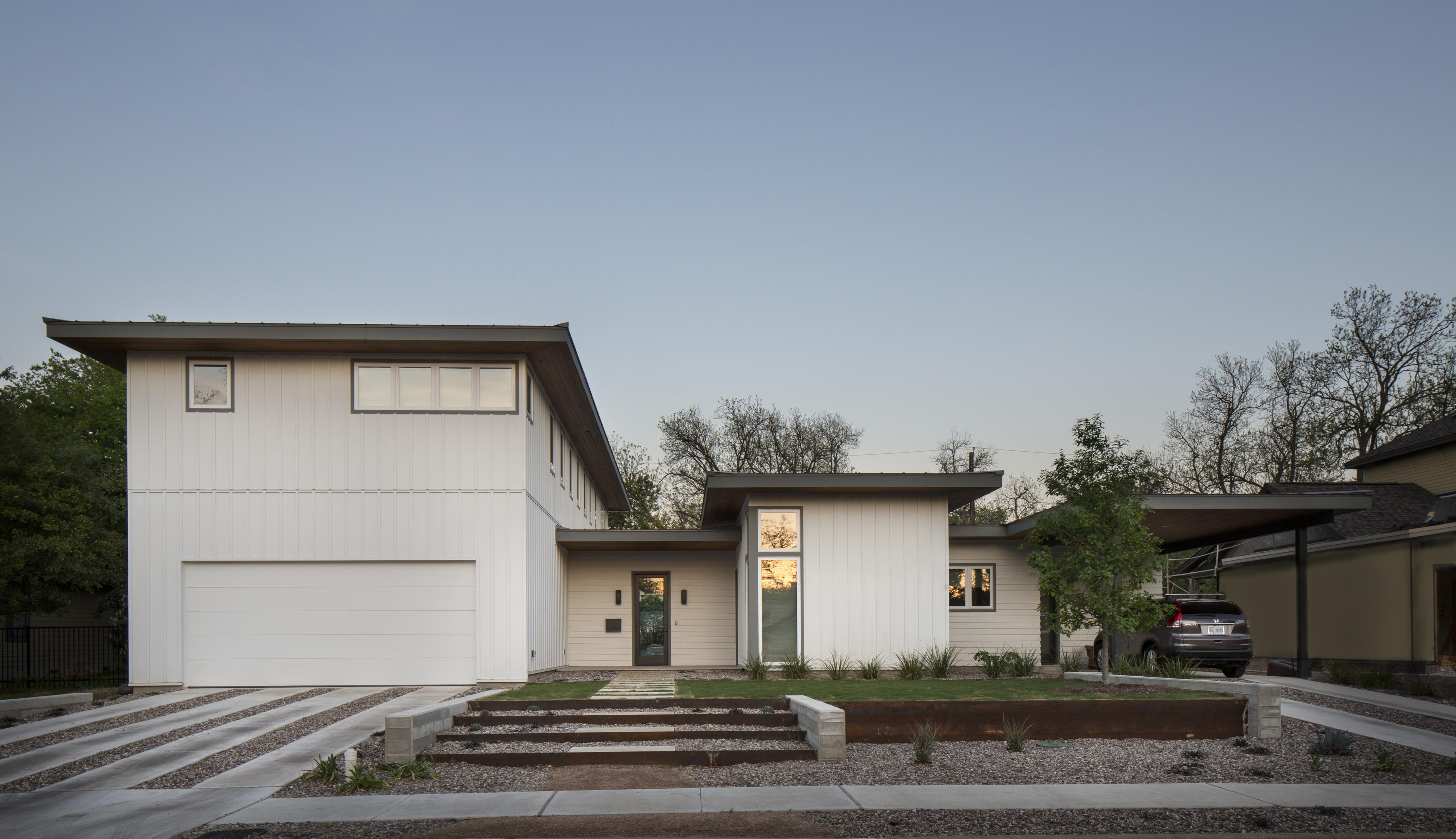 Simple modern home in Arctic White Hardie panel and board and batten siding