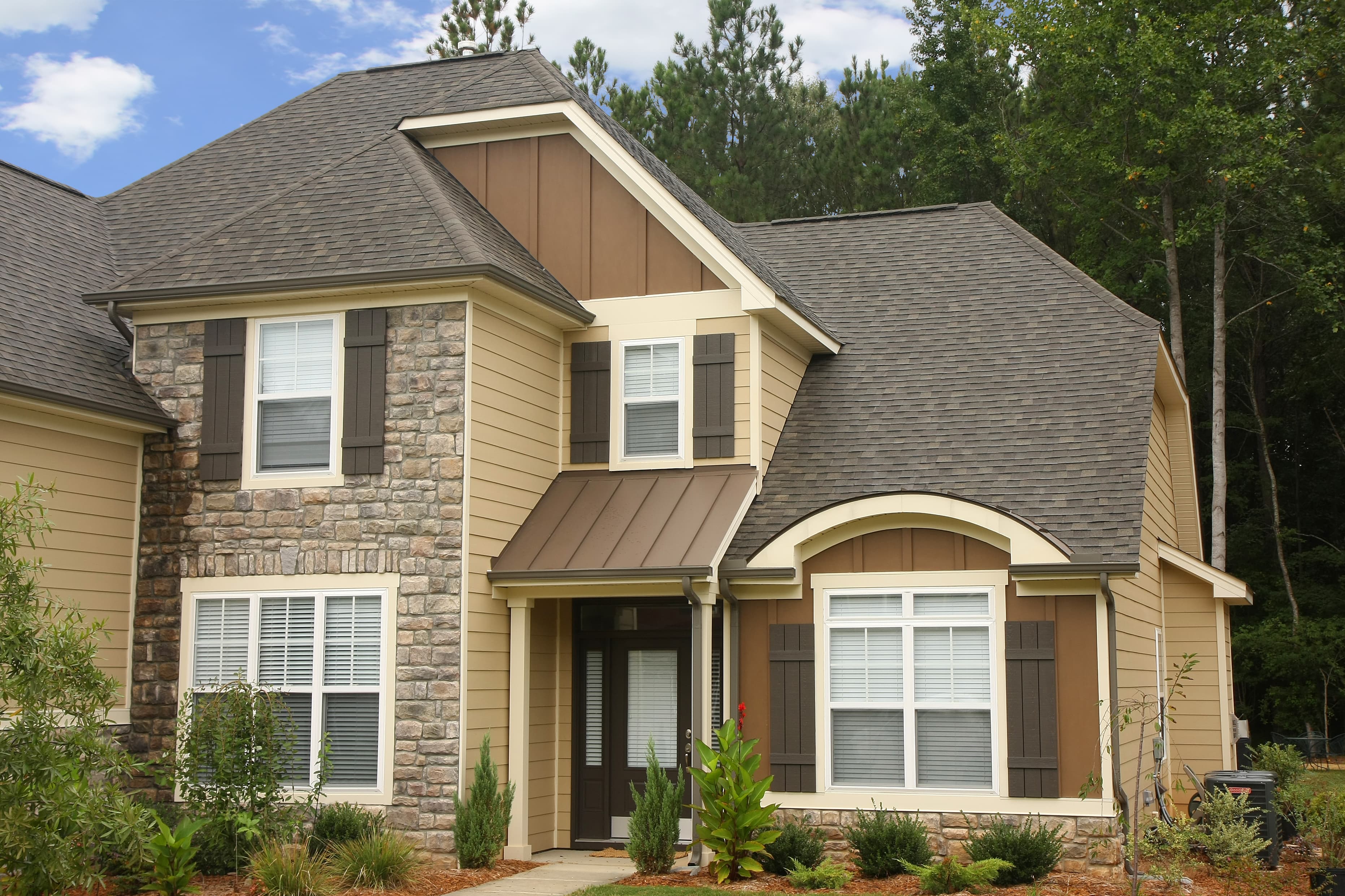 House clad in Hardie® Plank Lap and Hardie® Board and Batten trim in custom brown colors