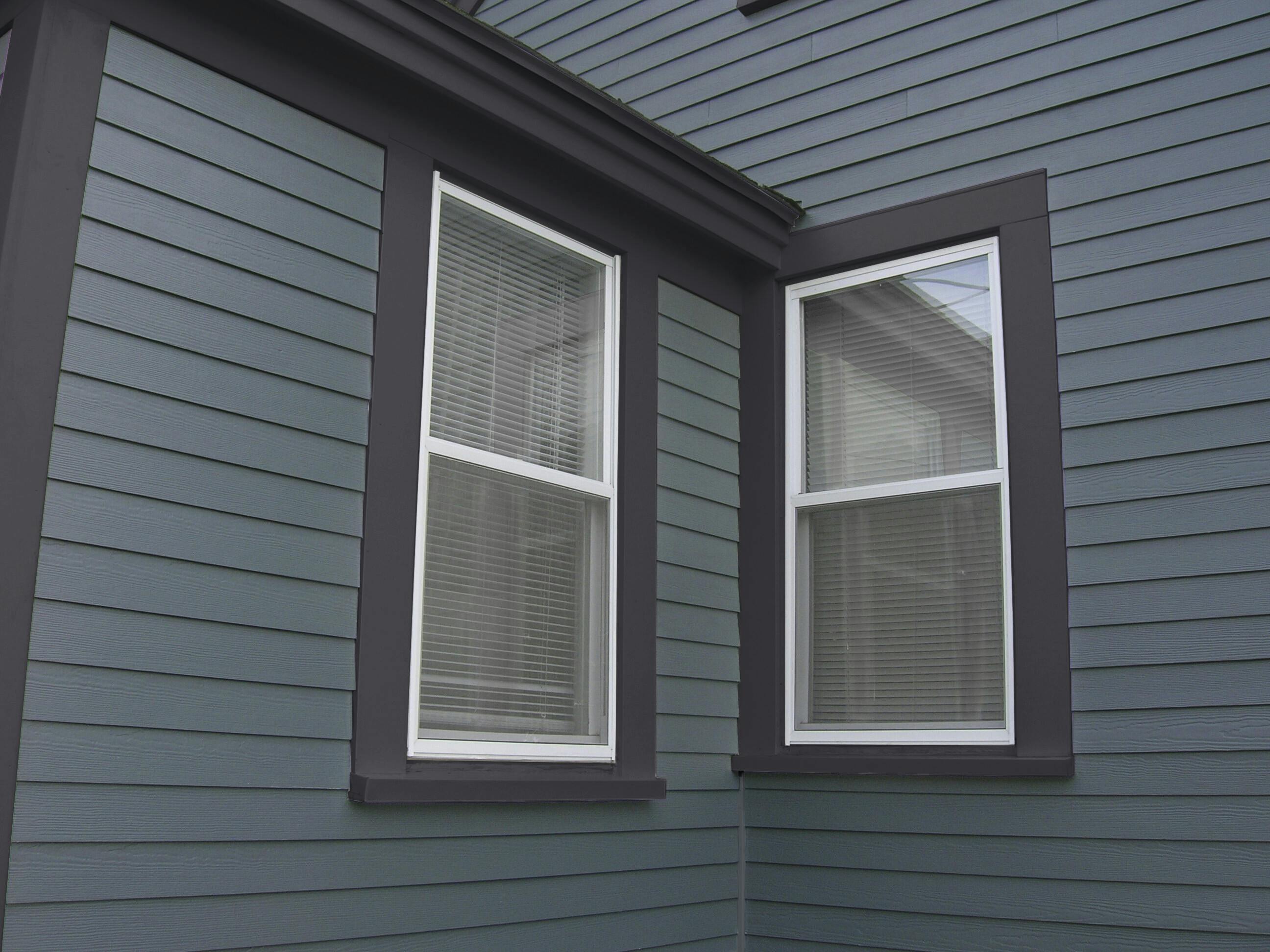 A close up detail of blue Hardie Plank lap with dark blue Hardie Trim 