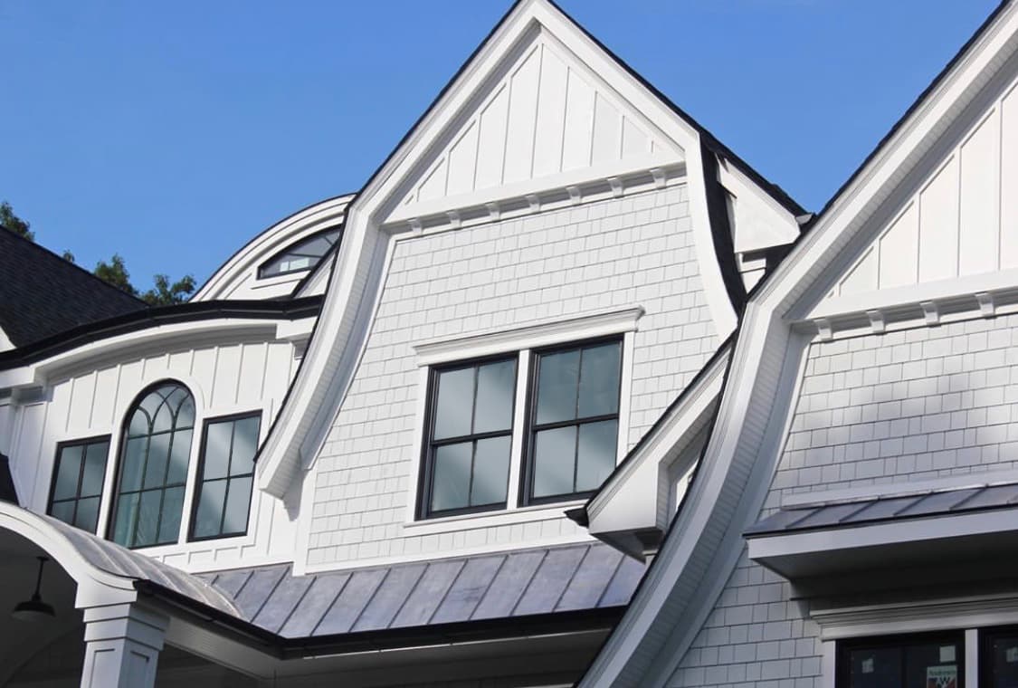 Detail of a gable with Hardie® Board and Batten siding and Hardie® Shingle in Arctic White