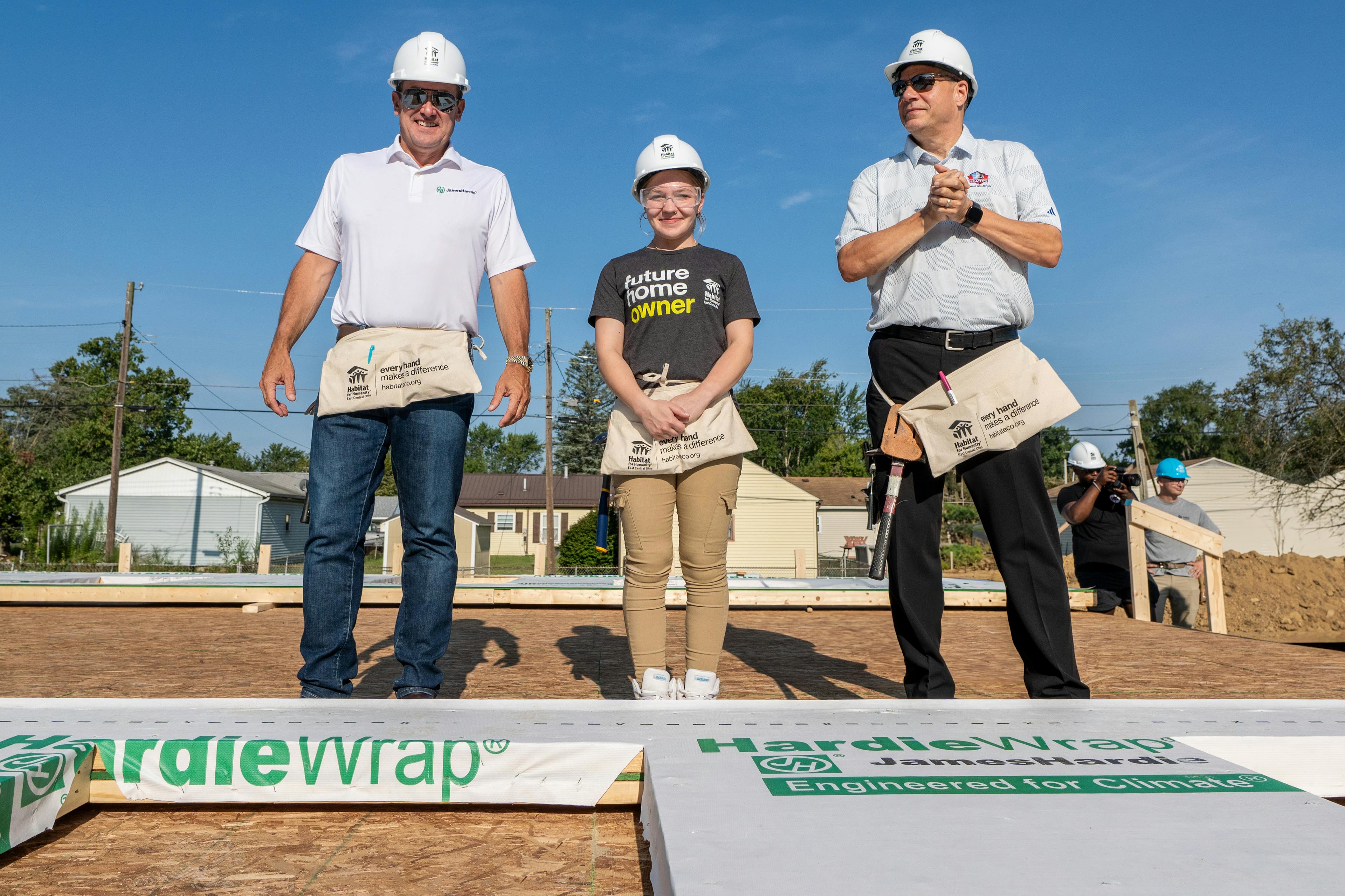 Aaron Erter, CEO of James Hardie, Brittany, future Habitat for Humanity homeowner, and Jim Porter, Pro Football Hall of Fame president.