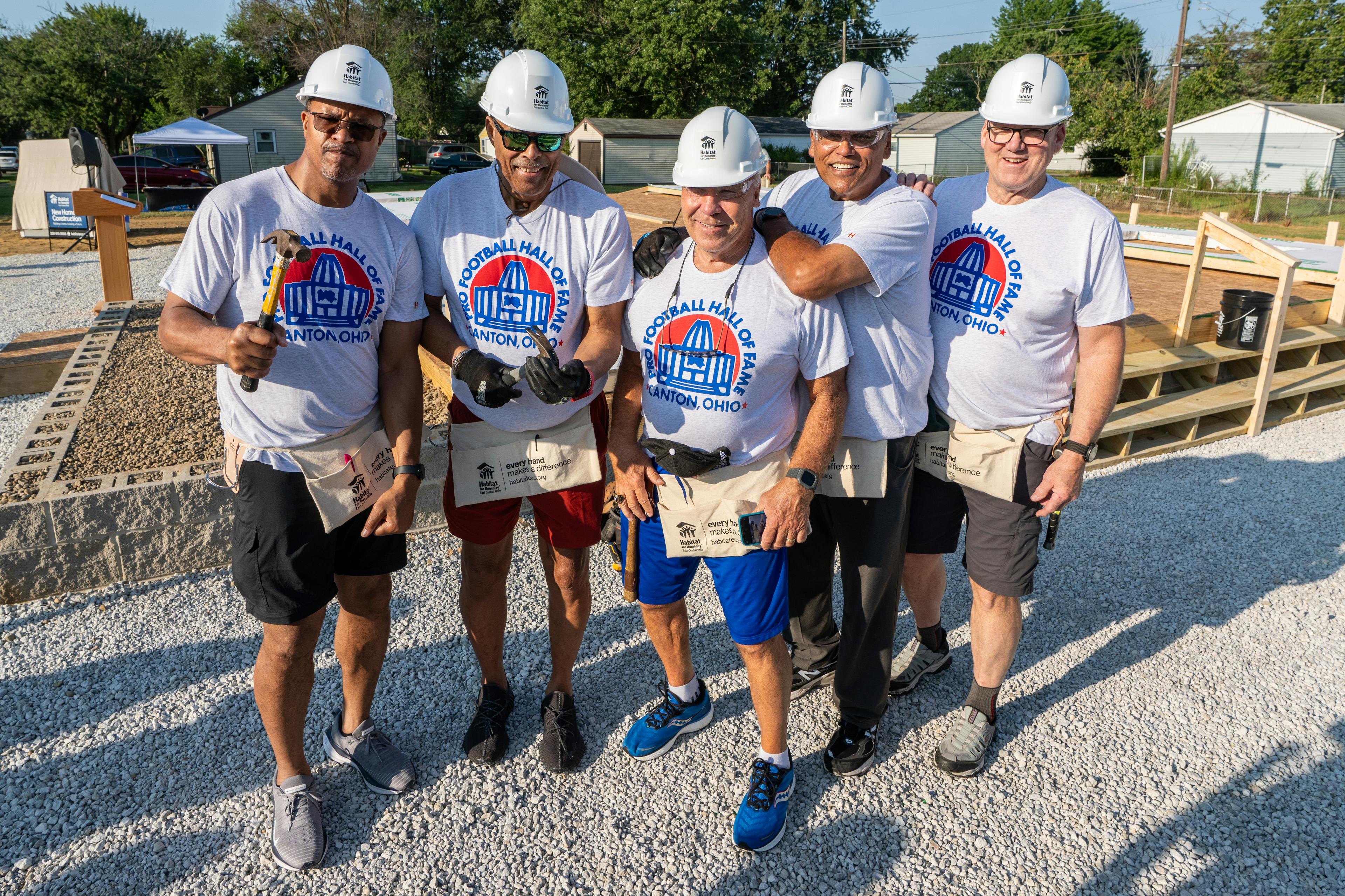  Pro Football Hall of Fame members volunteer to help raise the walls of a new Habitat for Humanity home being built for a family in Canton, OH. 